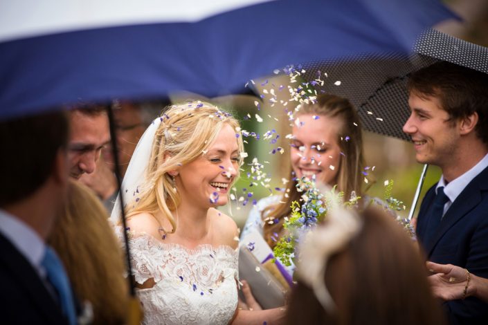 Bride being showered in confetti