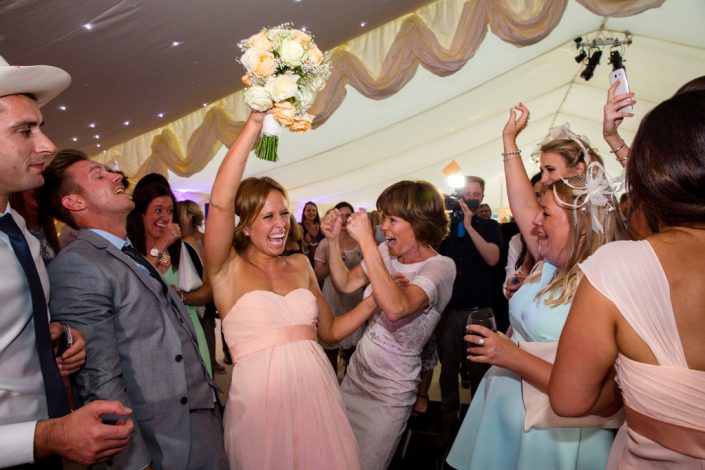 Bridesmaid catches the bouquet