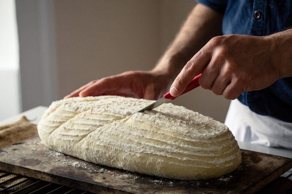 Baker slashing loaf of bread prior to baking, Hobbs House Bakery, Tom Herbert, Fabulous Baker Brothers