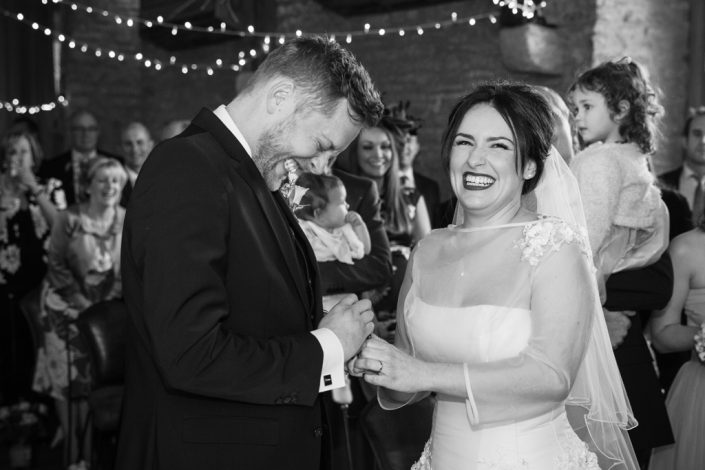 Bride & Groom laughing during service