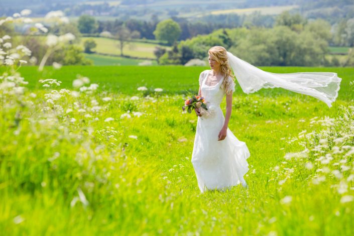 Bride posing on hillside