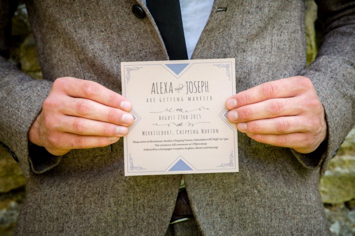 Groom holding Wedding invitation