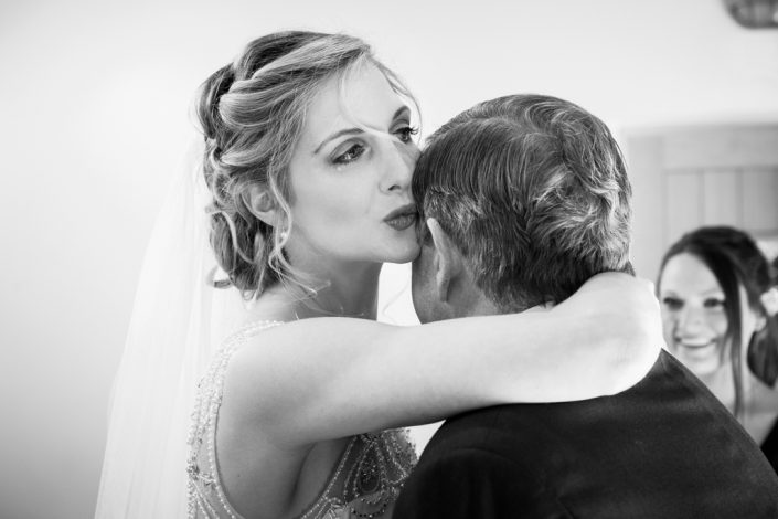 Emotional Bride kissing Father of the Bride